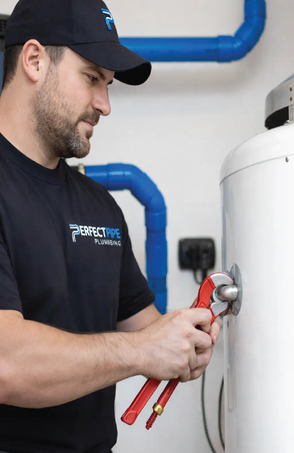 Perfect Pipe Plumbing technician repairing a residential water heater